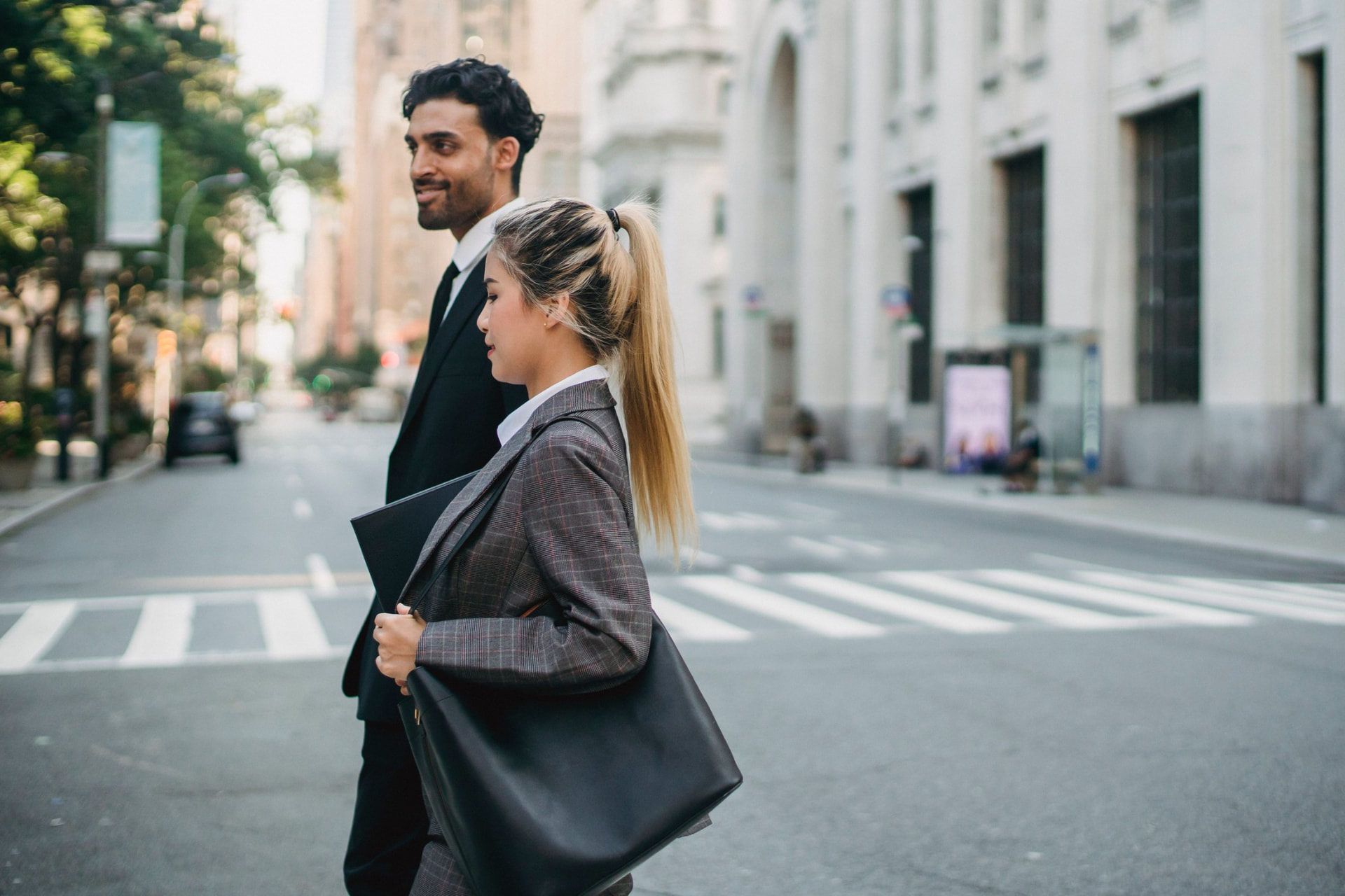 Two professionals walking together on a city street